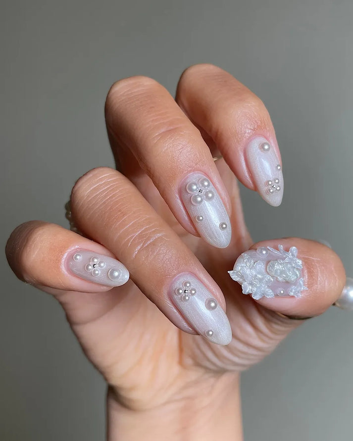 Ivory press-on nails with pearl iridescent shimmer and delicate 3D embellishments