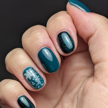 Short nails in deep teal with a high-gloss finish