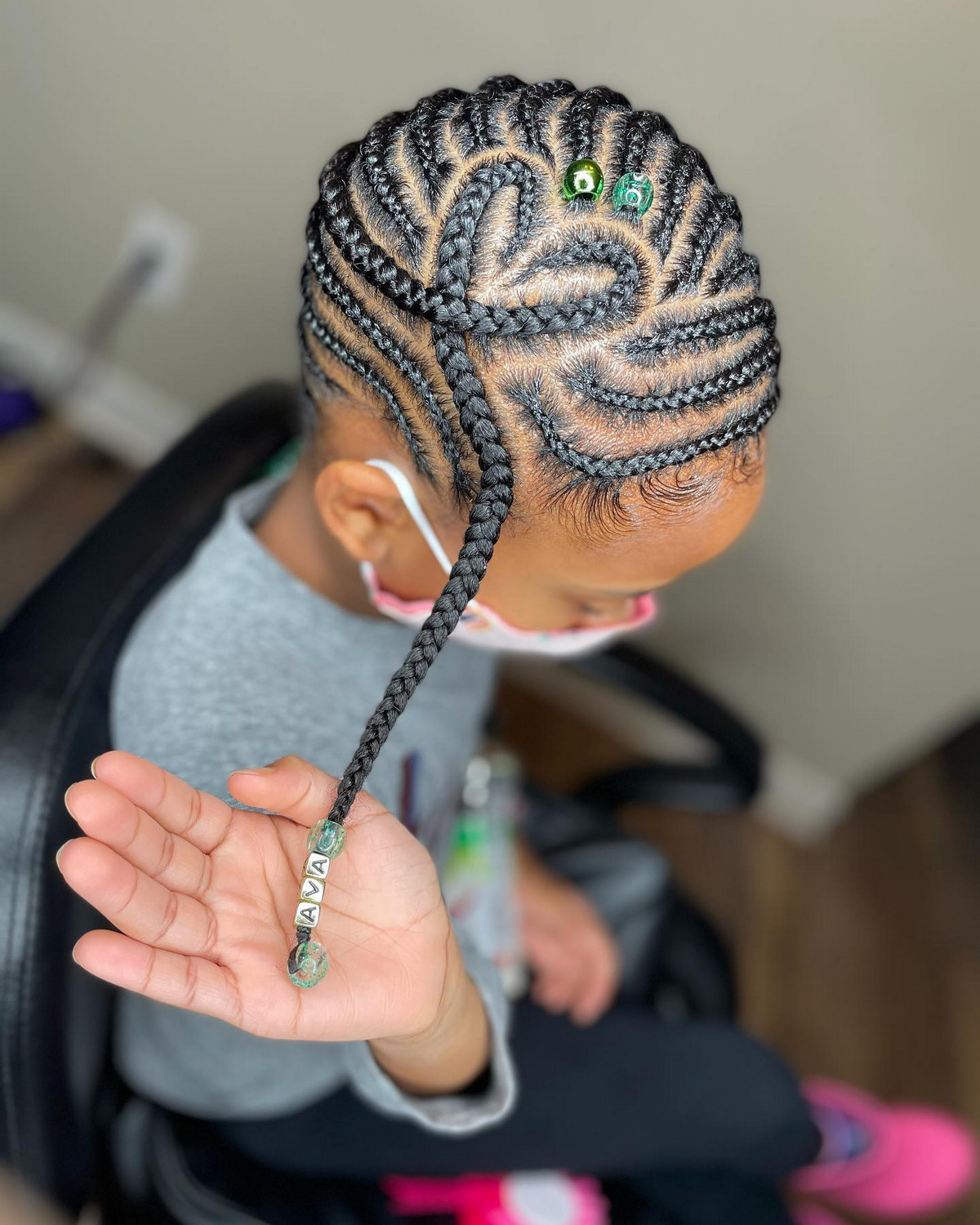 Lemonade braids swept to one side on a young girl