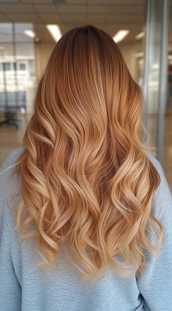 Long beachy waves in honey strawberry blonde balayage
