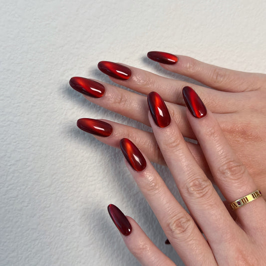 Medium almond nails in ruby-red velvet cat-eye magnetic polish