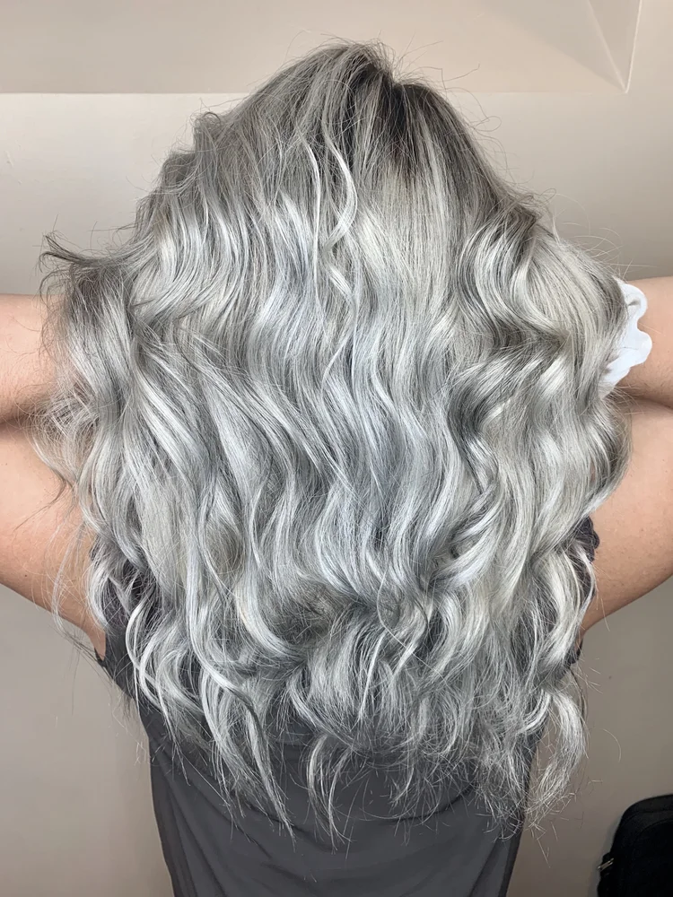 Long silver gray hair with luminous waves seen from behind