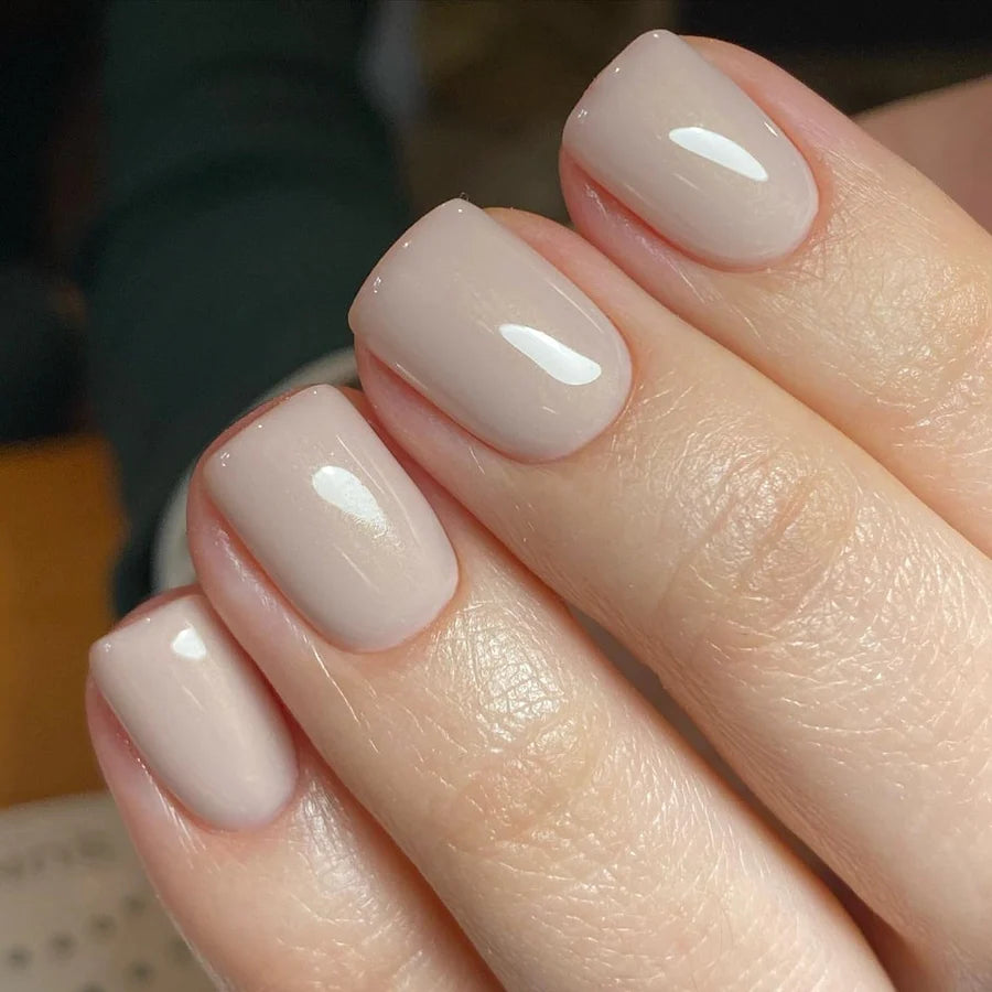 Short squoval nails in glossy warm greige beige polish