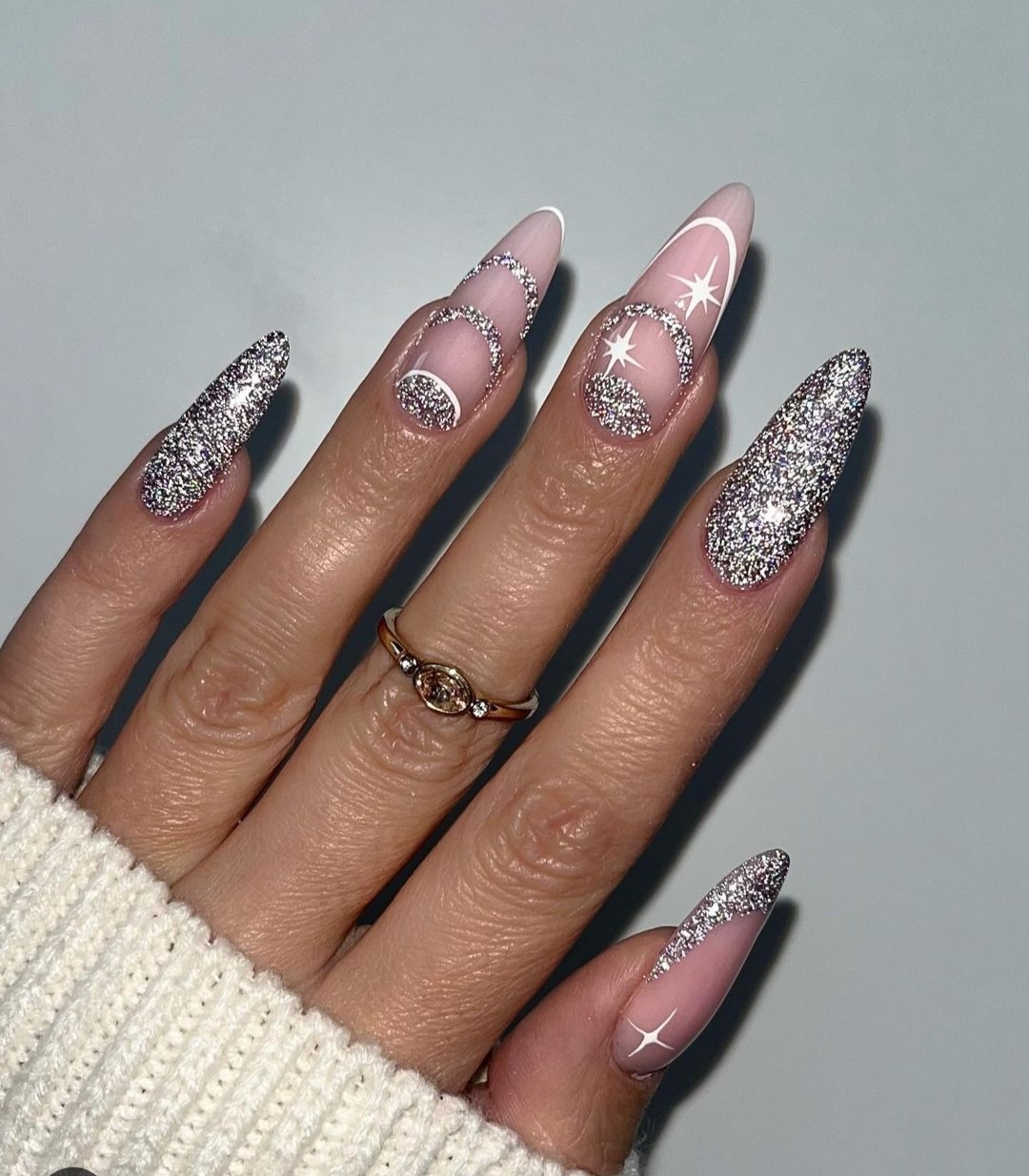 Almond nails with silver glitter crescent moons and star accents