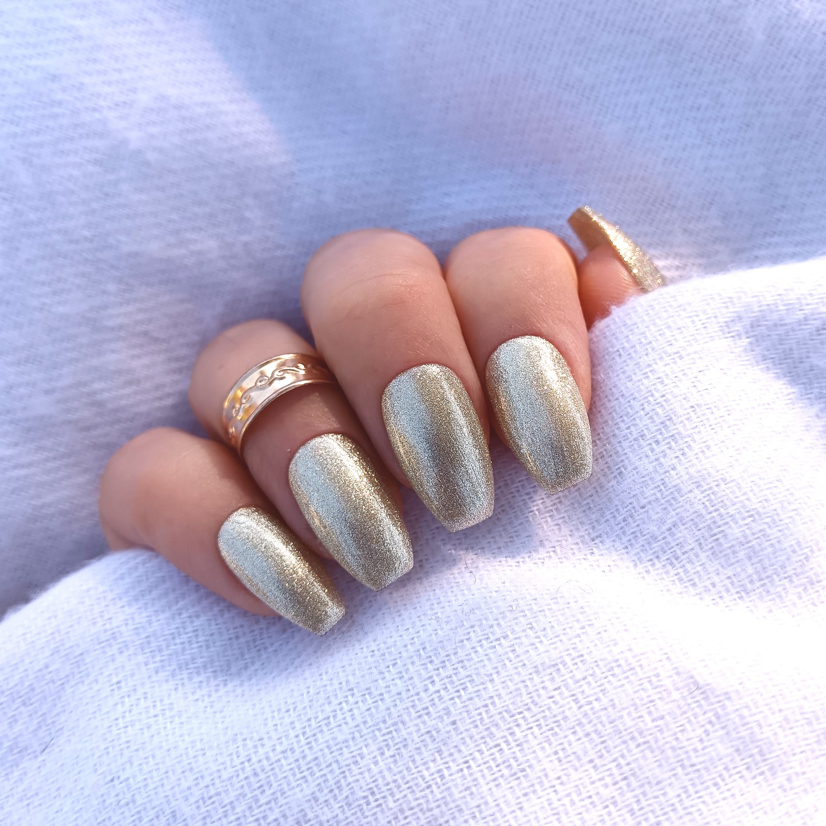 Coffin nails fully covered in champagne glitter polish
