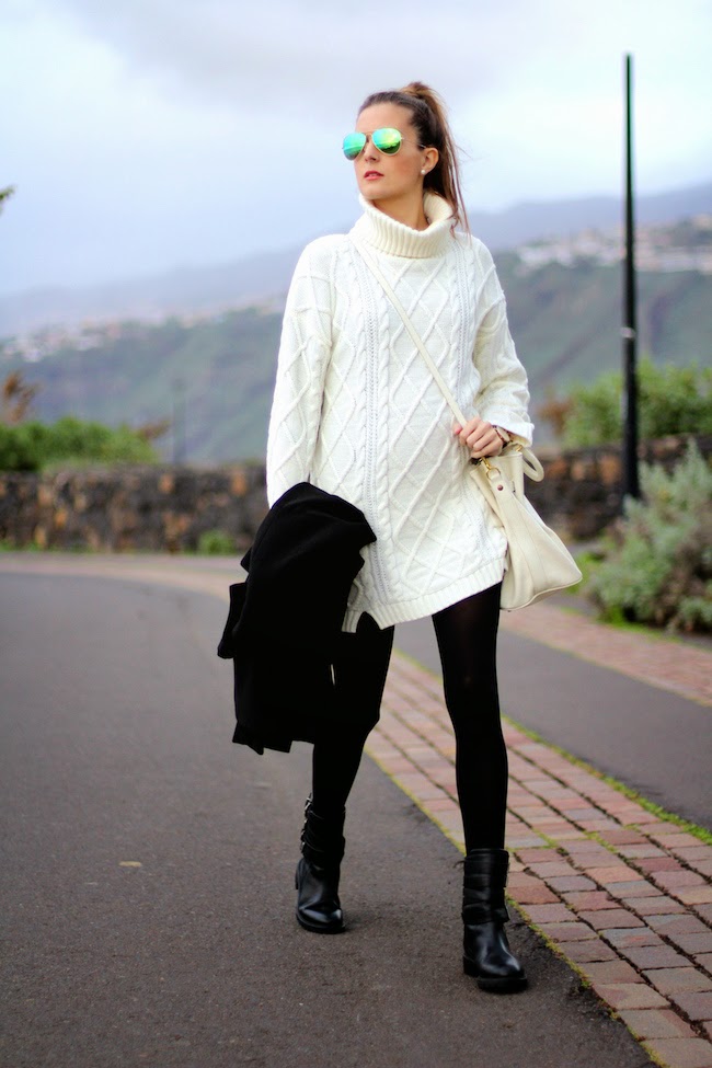 Cream cable-knit turtleneck mini sweater dress with black opaque tights, black ankle boots, a cream crossbody bag and mirrored sunglasses