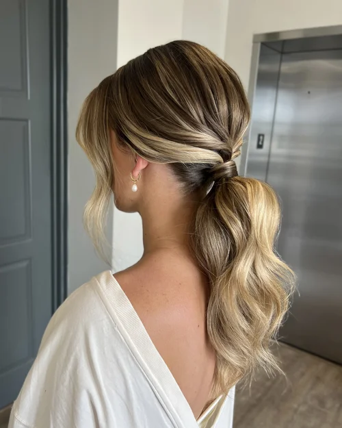 Brunette wavy low bridal ponytail