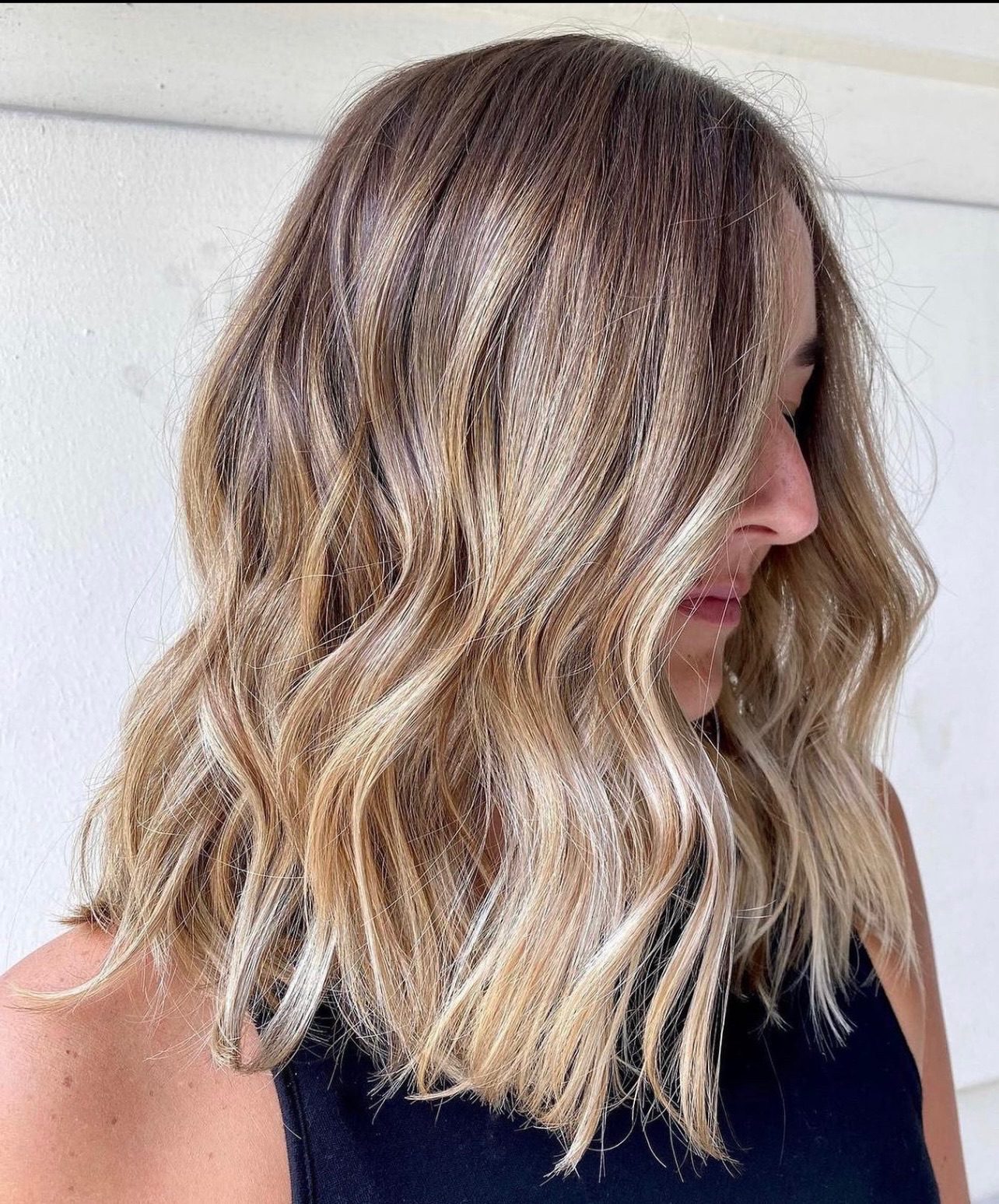 Beach waves in sandy blonde hair with espresso lowlights