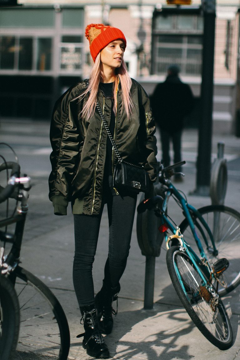Woman wearing a bomber jacket with jeans in a retro street-style look
