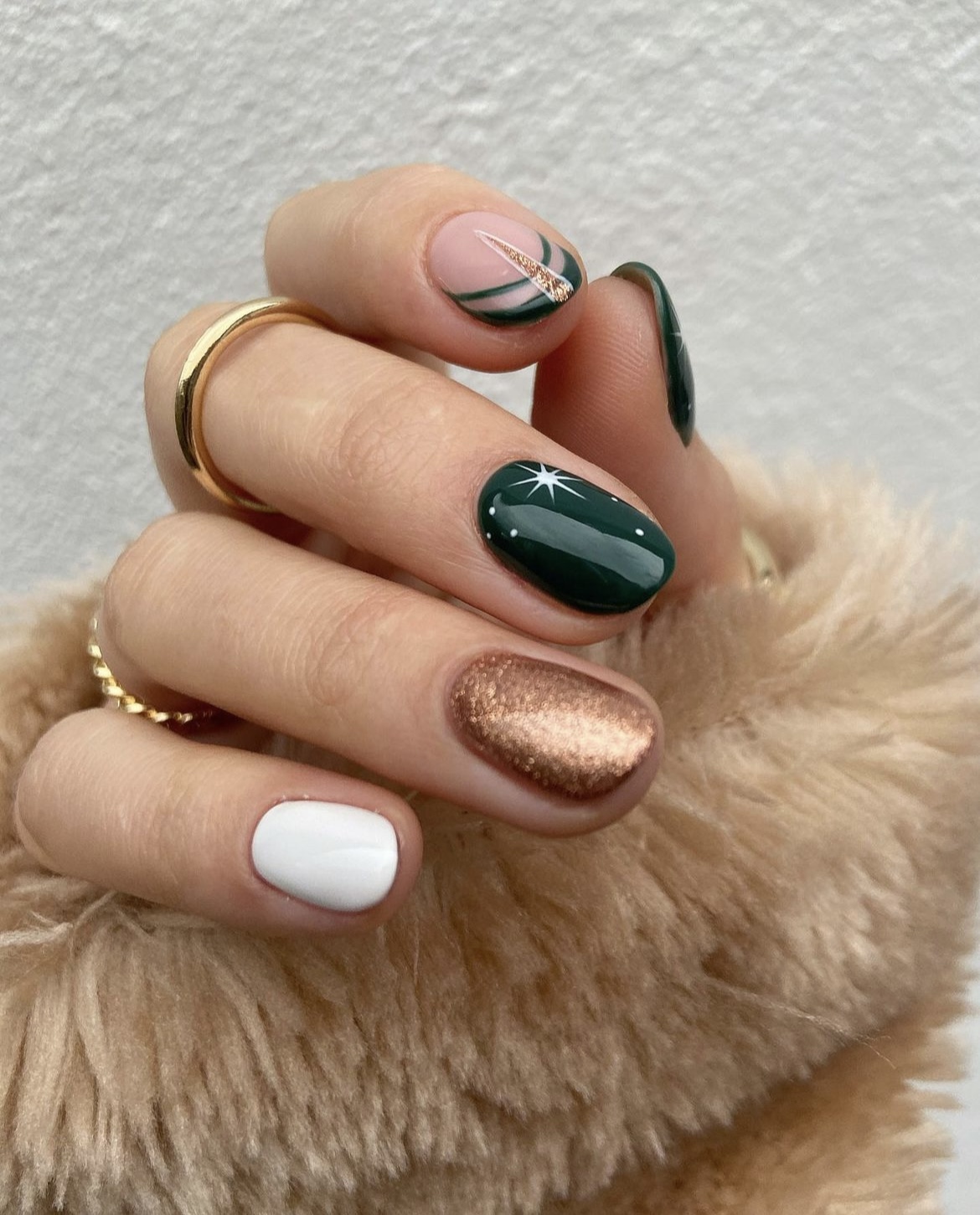 Mixed holiday gel nails in deep green, white and copper glitter with star art