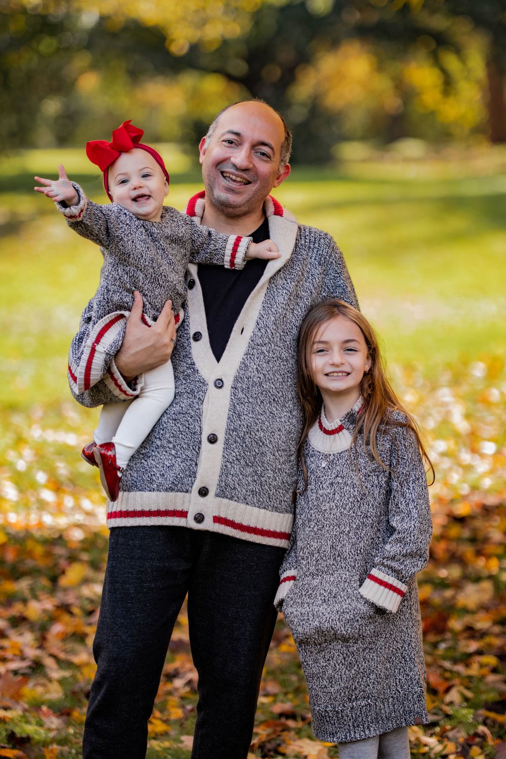 Family wearing cozy knit cardigans in a winter photoshoot