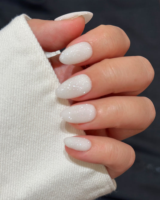 Pearl white nails with fine iridescent glitter dust
