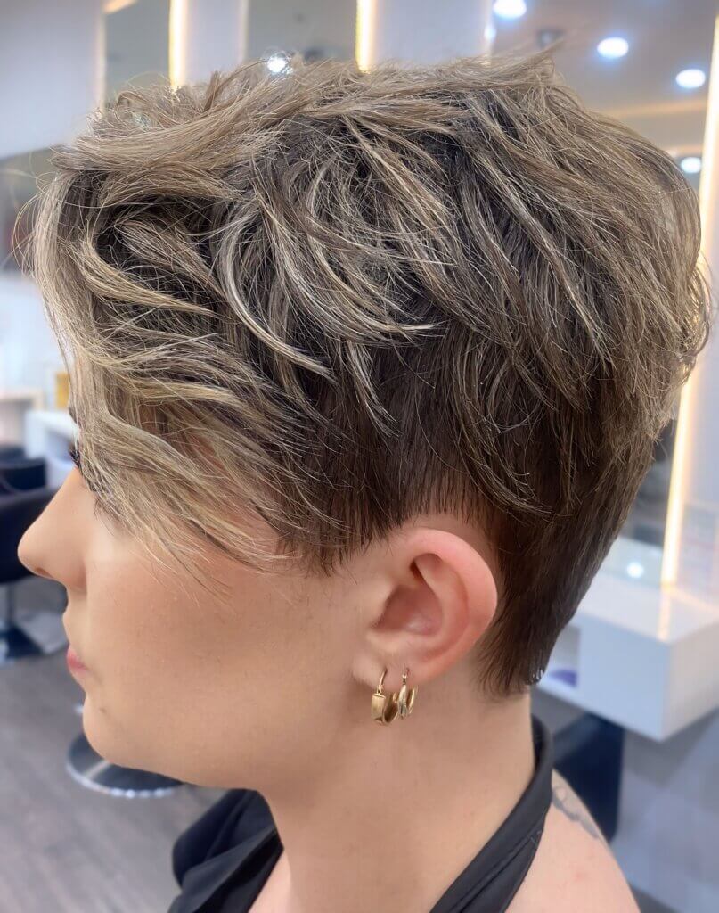 Shaggy pixie haircut with long textured crown layers