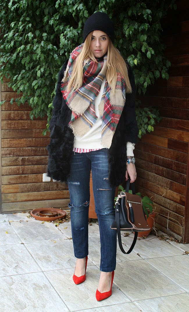 Black faux fur coat with a plaid scarf, ripped jeans and red heels