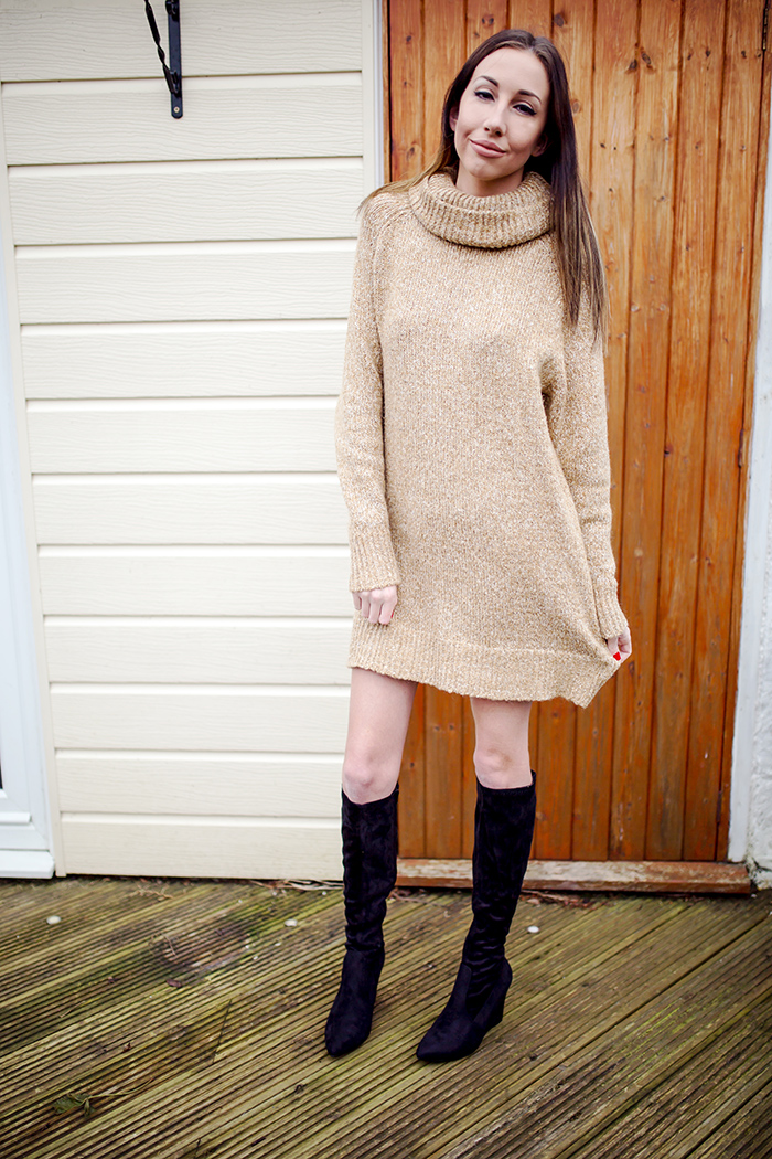 Woman in a beige turtleneck sweater dress with black over-the-knee boots