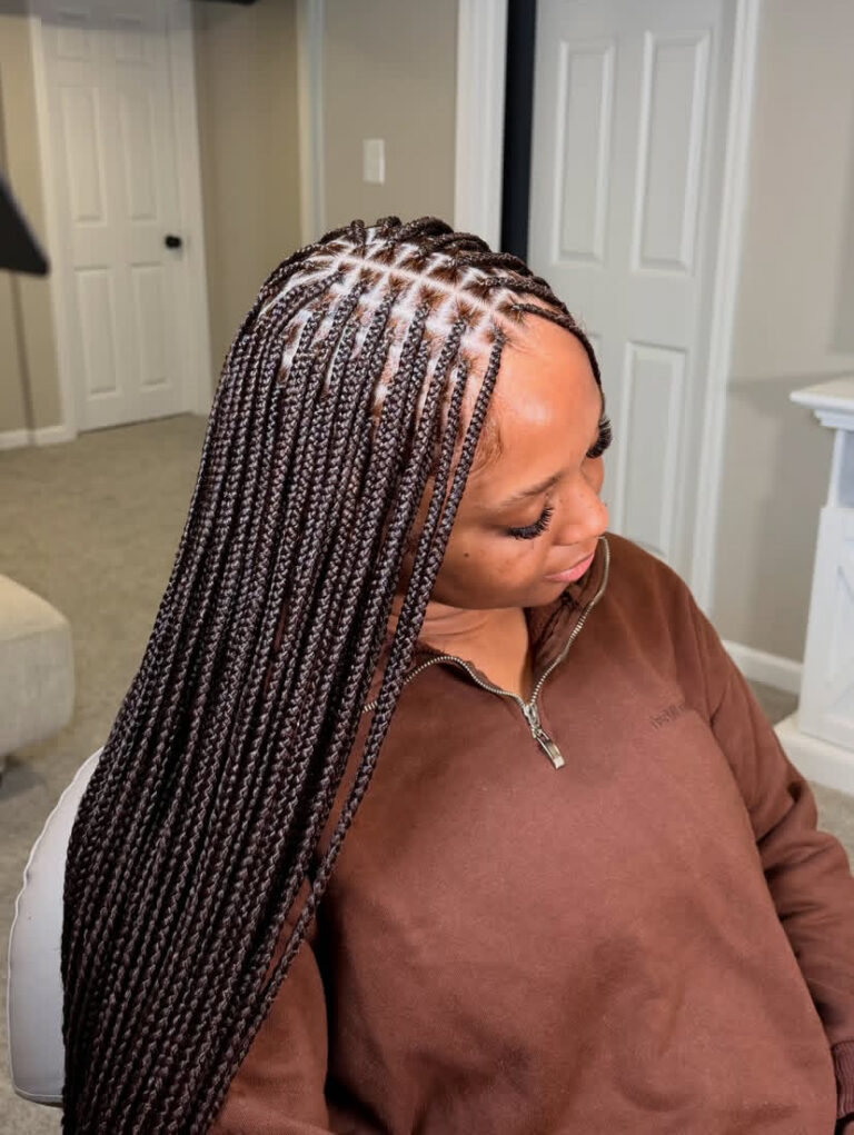 Long chocolate brown knotless braids with neat square parting