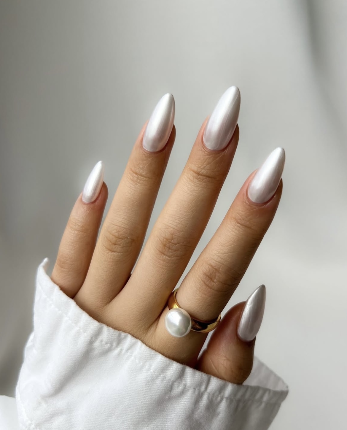 Long almond nails in glossy white pearl-chrome finish
