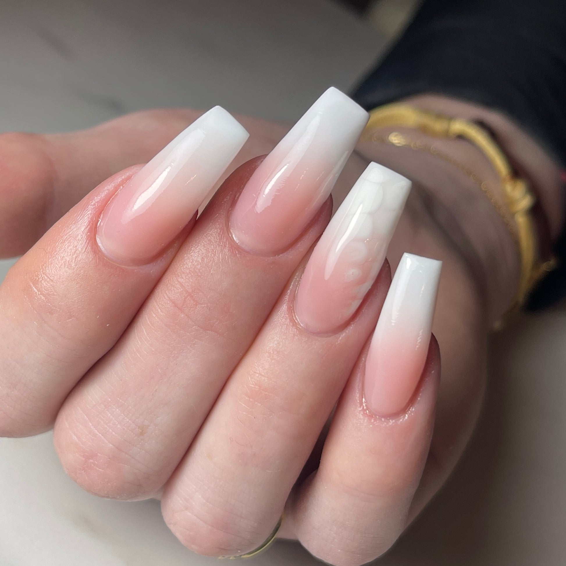 Long coffin nails with a milky white baby-boomer fade