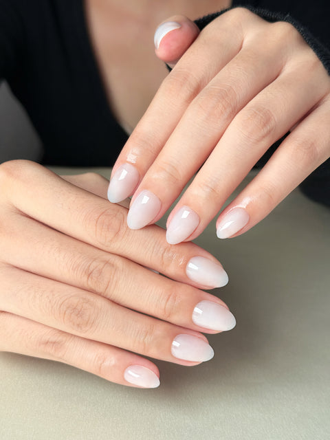 Translucent milky white jelly nails with a glossy glass-like finish