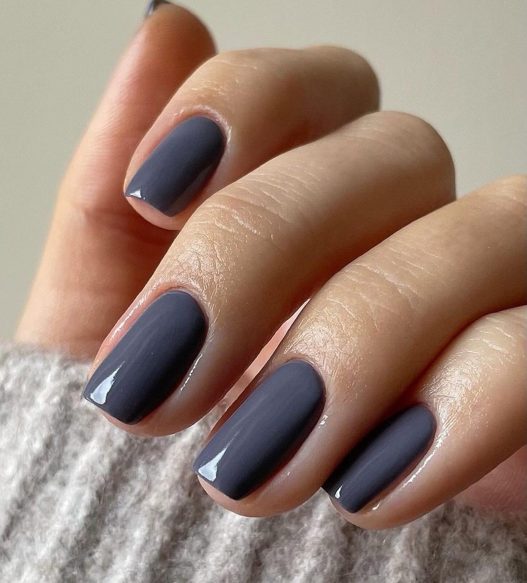 Slate blue-gray creme polish on short oval nails