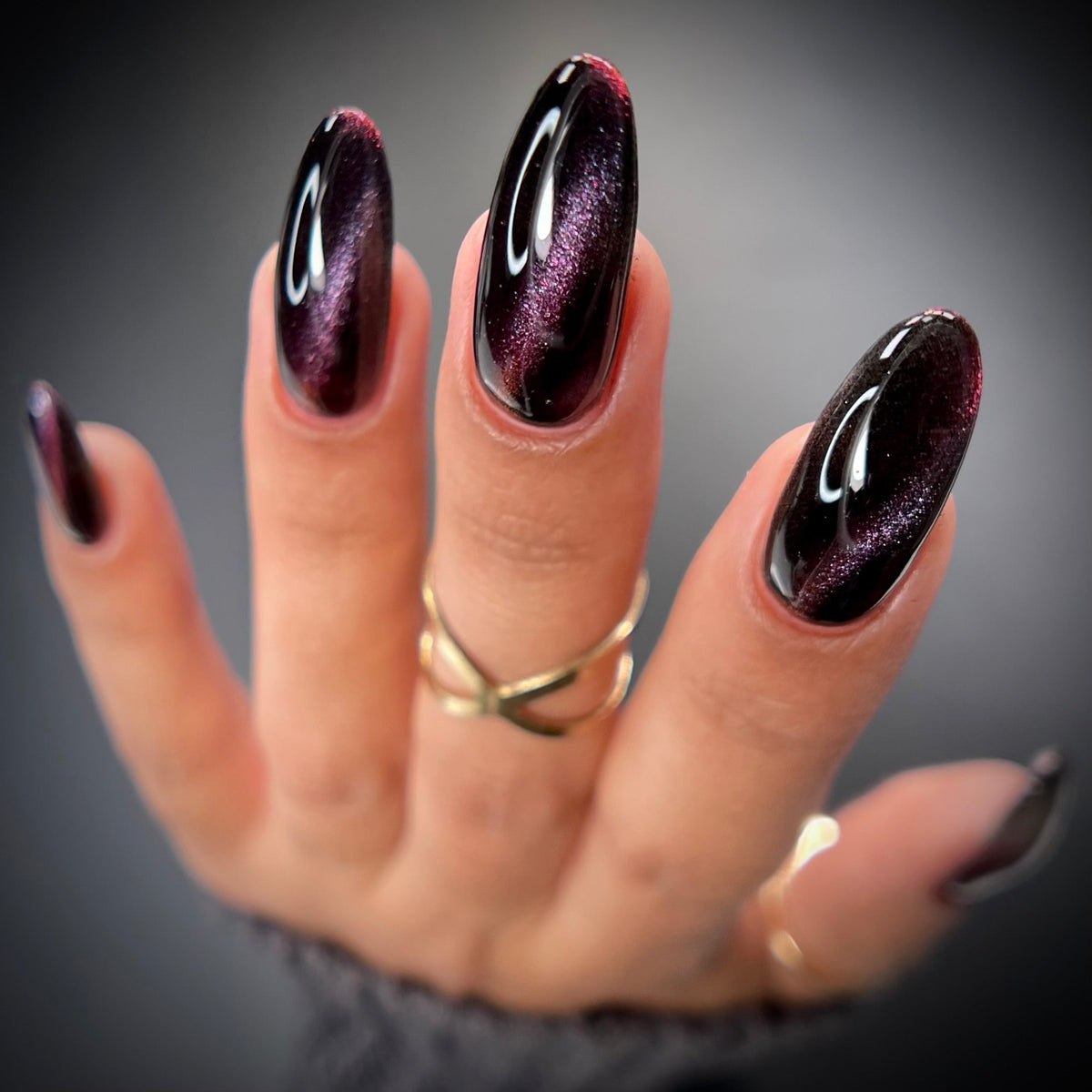 Dark plum cat eye nail polish shimmer