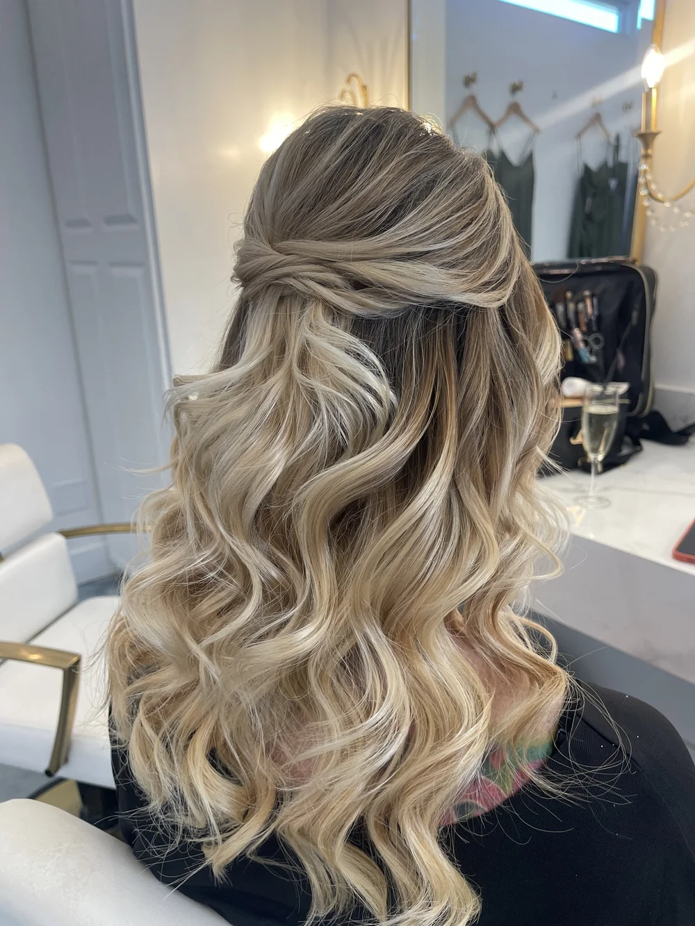 Half-up twisted crown on blonde curly bridal hair