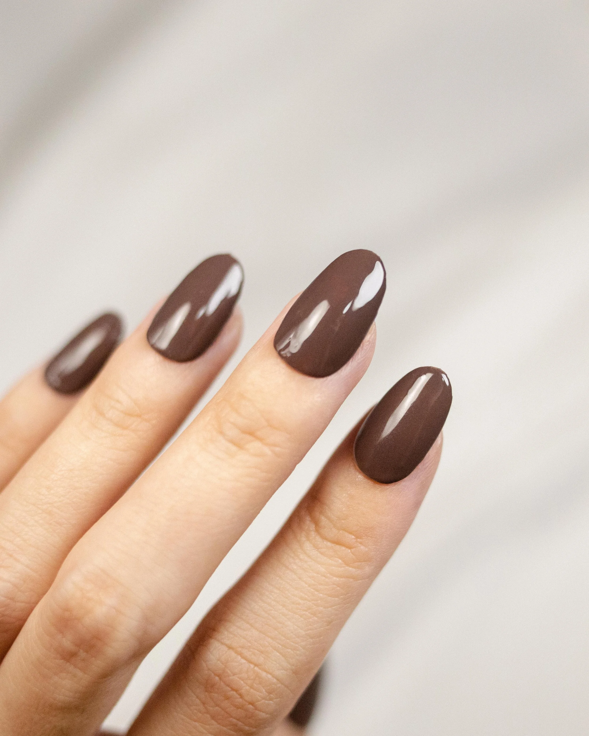 Almond nails in glossy chocolate brown polish