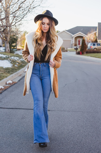 Shearling-style coat worn with dark jeans