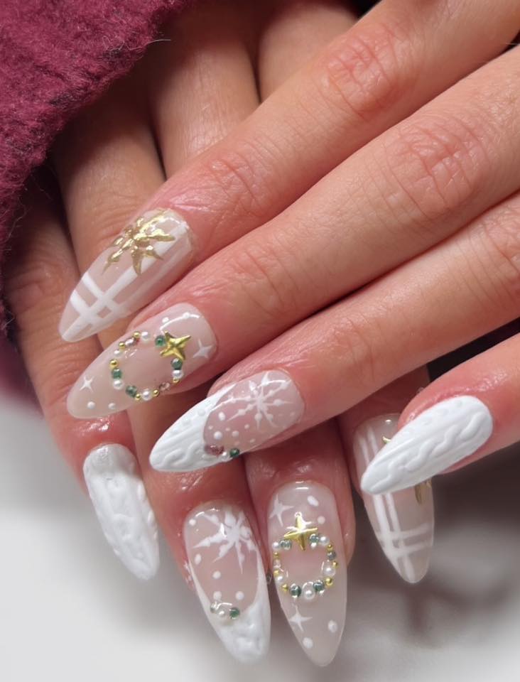 Pearl white stiletto nails with plaid stripes, snowflakes and gold star beaded wreath details