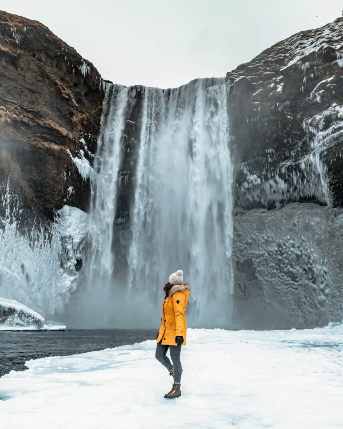 Woman in a storm parka on Iceland's south coast in winter