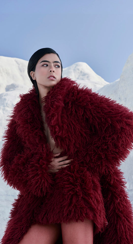 Woman wearing a shaggy faux fur coat set with slim winter boots