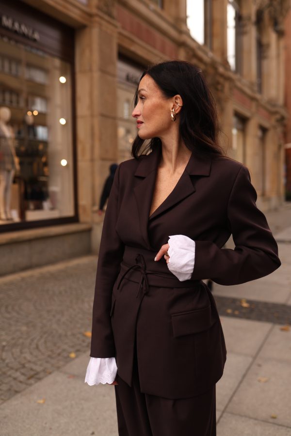 Woman wearing a chocolate brown blazer with tailored separates