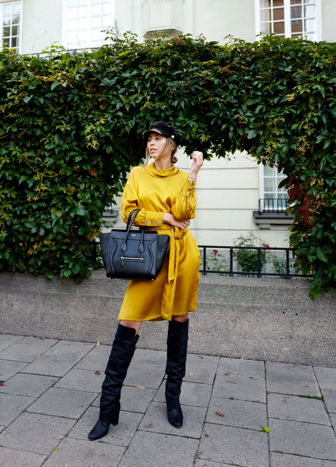 Mustard yellow satin wrap dress with black over-the-knee boots
