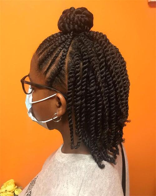 Side profile of kinky twists pinned into a small top bun