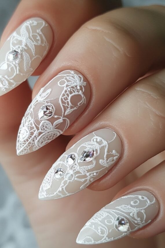 Ivory nude nails with delicate white lace print nail art