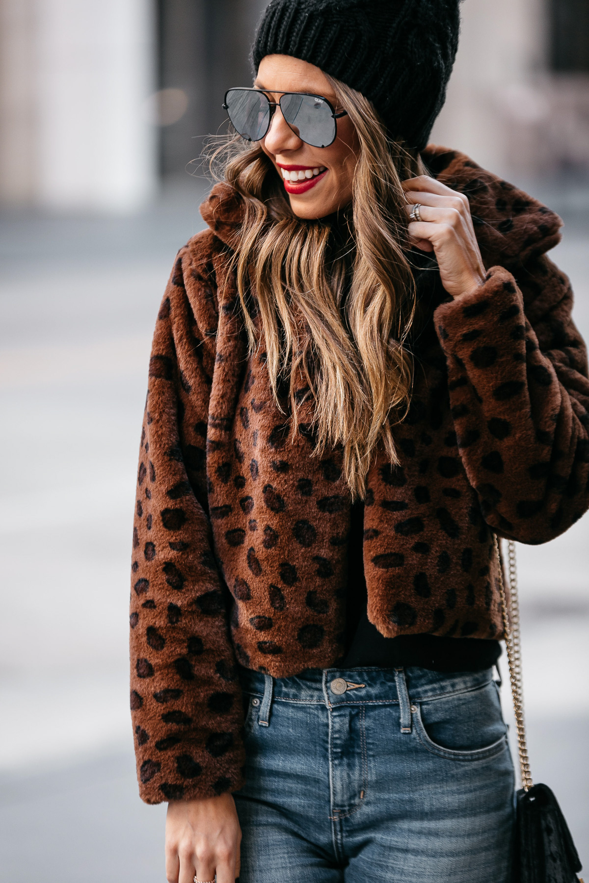 Fashion blogger wearing a leopard faux-fur jacket over black basics