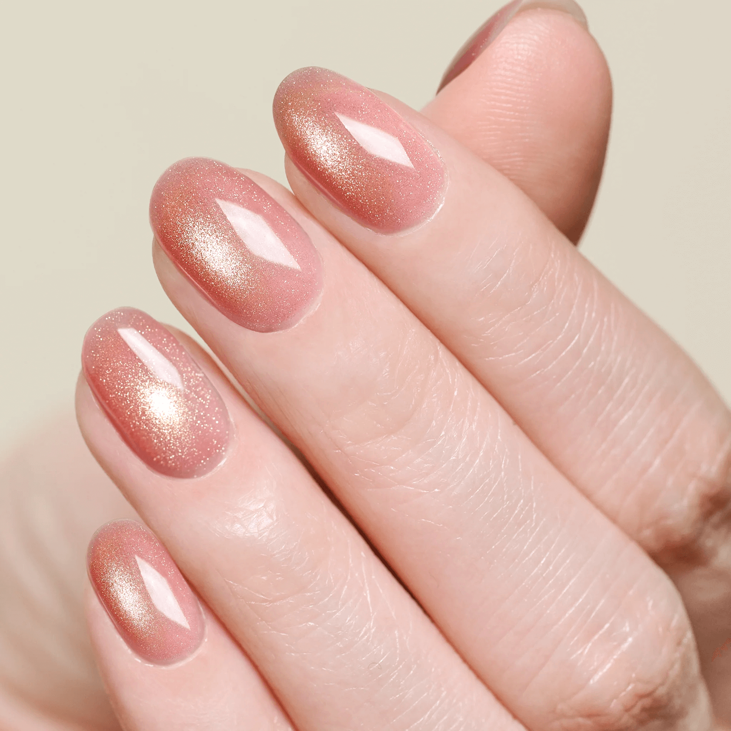 Rose gold shimmer gel nails with a metallic finish