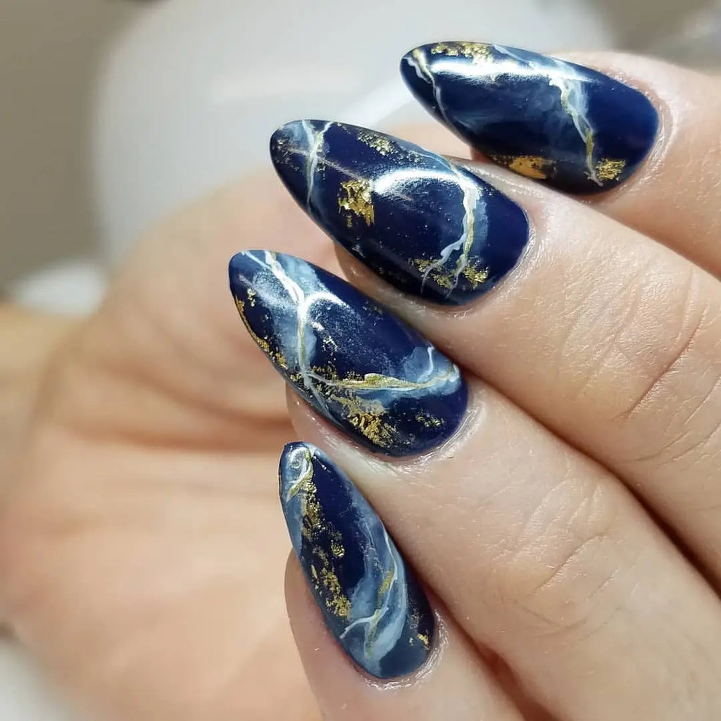 Navy blue marble nail art with gold veining