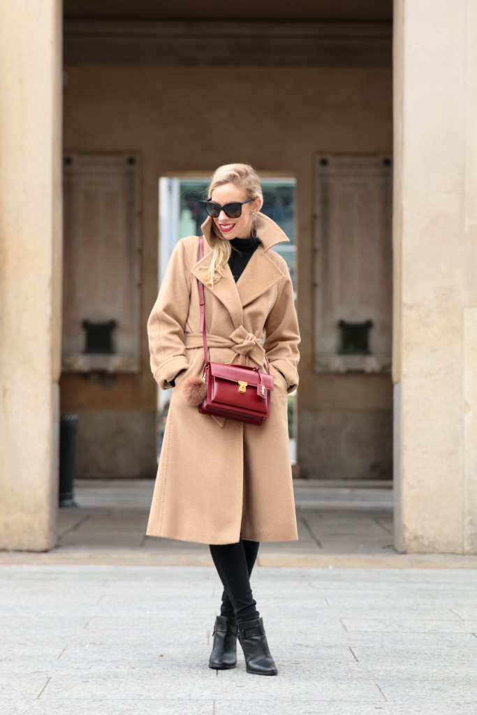 Woman wearing a camel wrap coat with a scarf, classic winter style