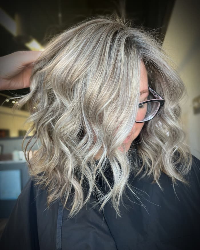 Ash blonde curly bob with darker roots