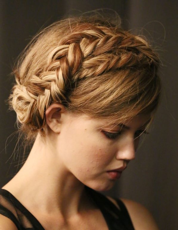 Blonde milkmaid-style braided crown updo with soft loose texture, from a Rebecca Minkoff bridal shoot.