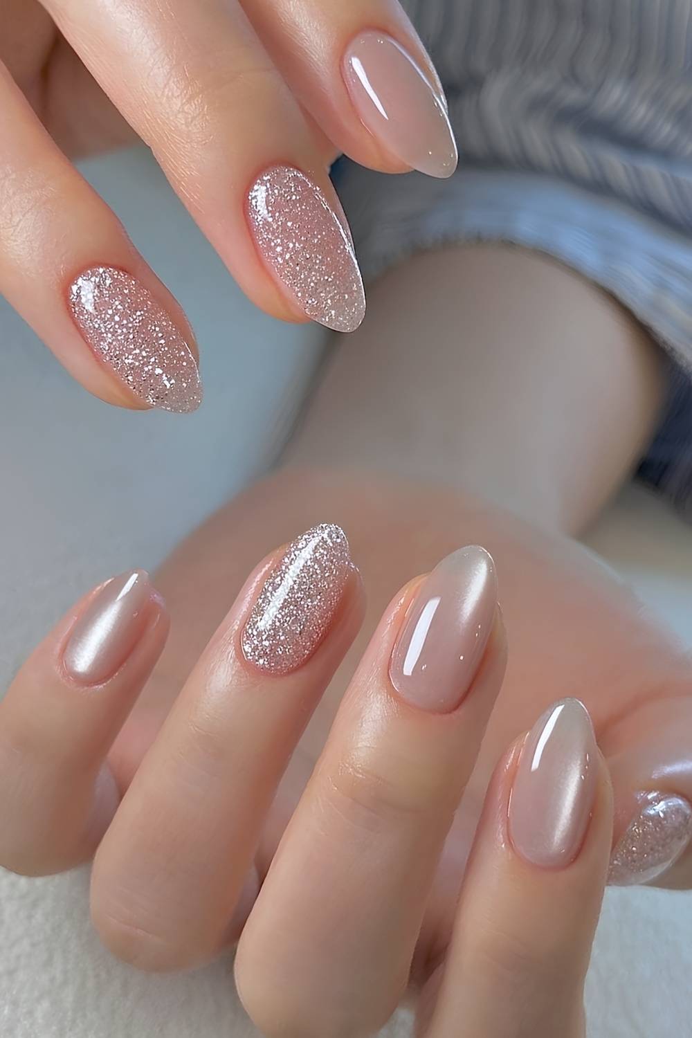 Almond nails alternating milky nude chrome nails with full silver glitter nails