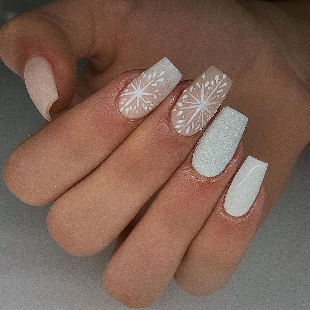 Minimalist snowflake line art on neutral nails
