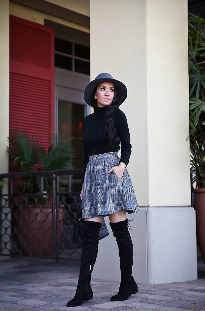 Plaid mini skirt with a black turtleneck and over-the-knee boots
