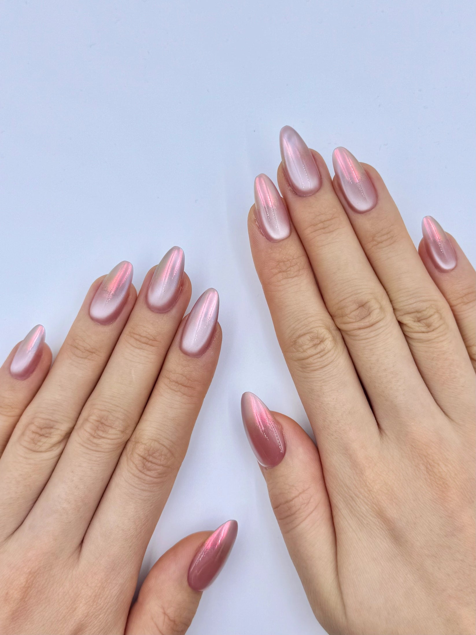 Mauve chrome nails with a pink cat-eye sheen