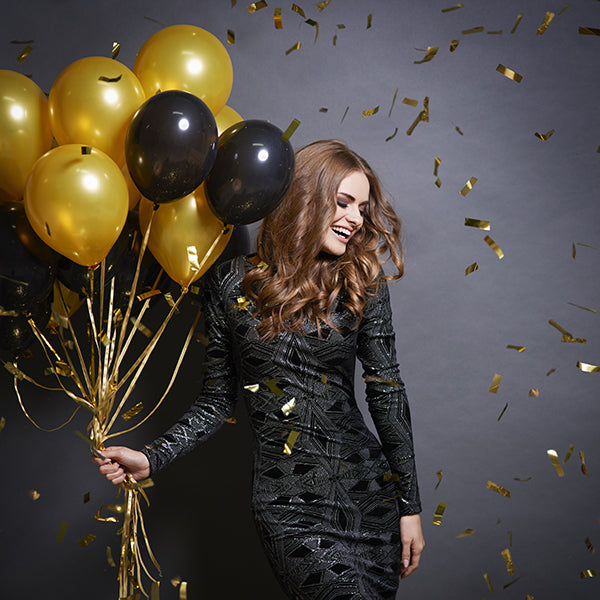 Woman wearing a black sequin dress for New Year's Eve