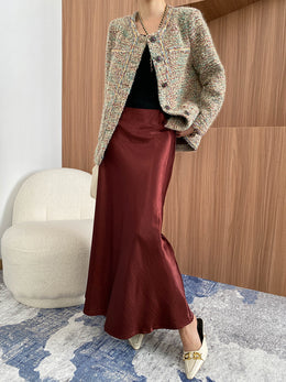 Tweed jacket with black top and burgundy satin midi skirt