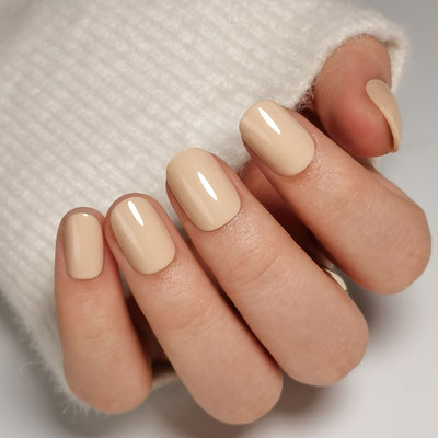 Short round nails in sheer taupe nude polish