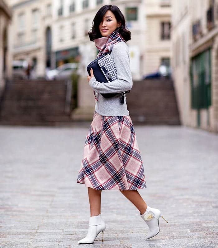 Grey sweater with a plaid midi skirt and a matching plaid scarf