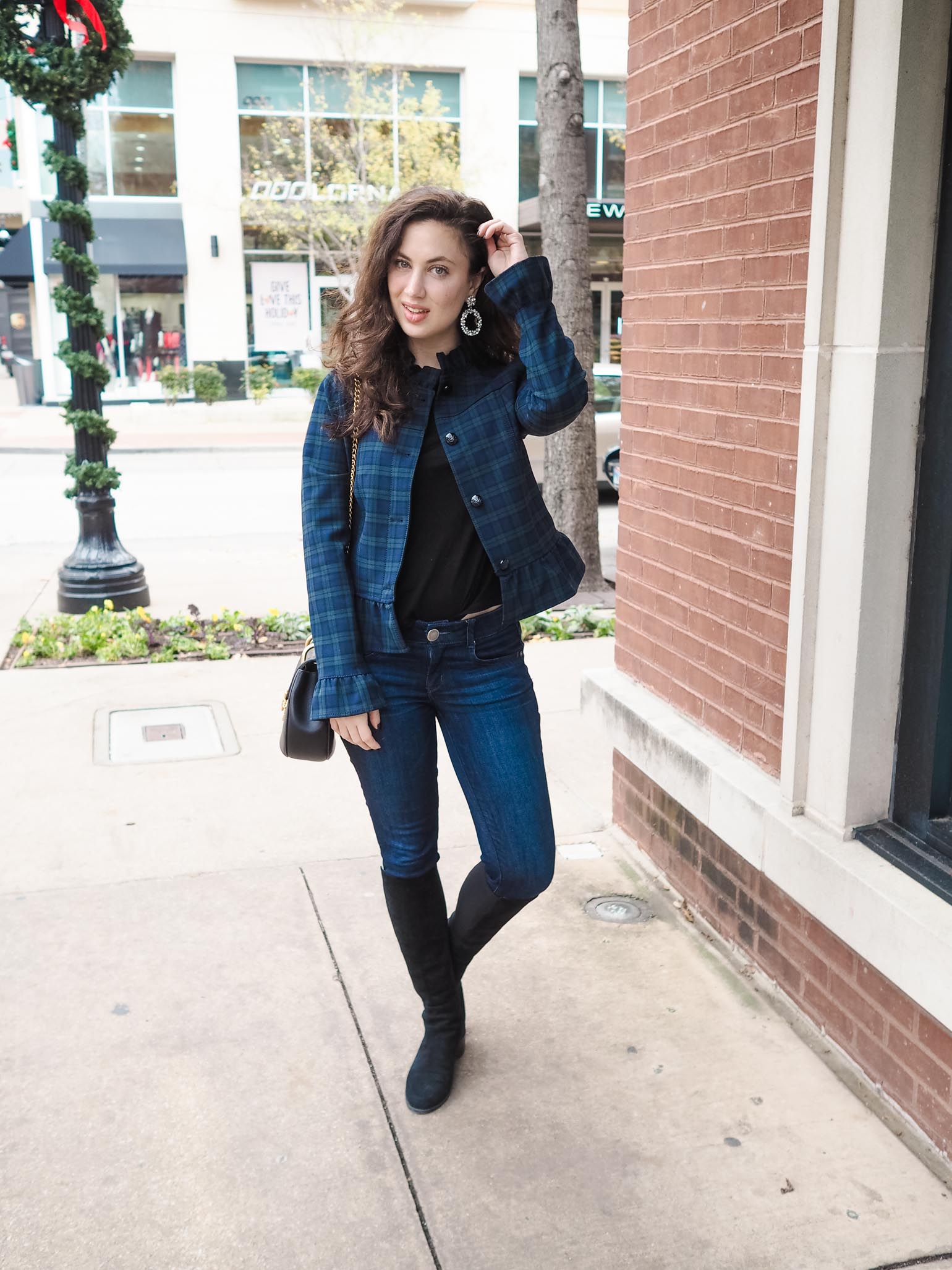 Navy plaid jacket with a ruffled hem worn with skinny jeans and over-the-knee boots